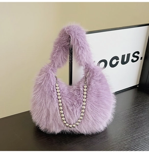 Detail of light purple faux fur handbag with stylish silver beaded chain decoration