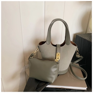 Detailed shot of sage green bucket bag with gold H-buckle and matching crossbody pouch