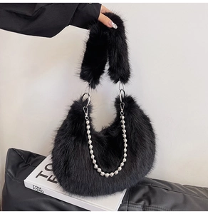 Detail of black faux fur hobo bag with plush texture and silver bead chain strap