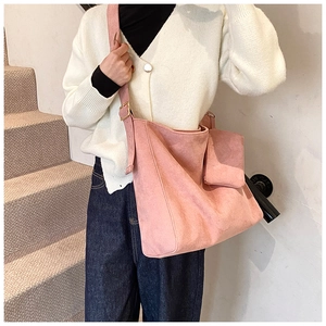 Detailed close-up of pink frosted leather tote bag with stylish small matching pouch