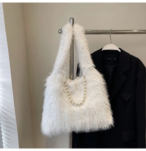 Detailed shot of white faux fur tote bag featuring elegant large pearl chain decoration