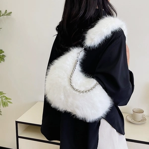 Detail of white fluffy crossbody bag with elegant silver beaded chain and plush strap