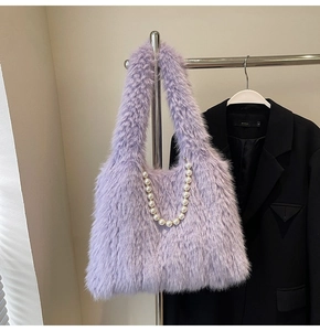 Detail of light purple plush tote bag featuring elegant pearl chain strap and soft faux fur texture