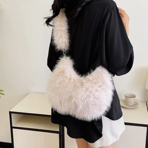 Detail of soft pink faux fur texture and metal buckle on this plush shoulder bag