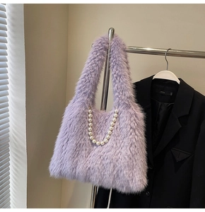 Detail of purple faux fox fur handbag with white pearl decorative chain strap
