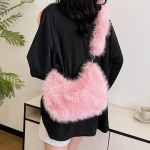 Pink plush faux fur crescent crossbody bag with chain detail for women early autumn style