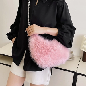 Detail view of pink heart-shaped faux fur bag with elegant white pearl bead strap