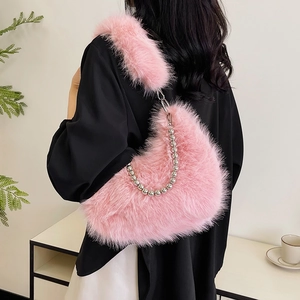 Detail of pink faux fur shoulder bag featuring silver bead chain and plush texture
