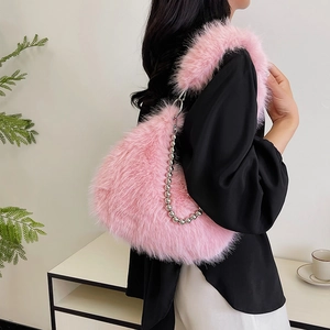 Detail showing soft pink plush crescent bag with a decorative silver beaded metal chain