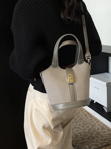 Retro grey bucket bag with suede texture, gold buckle and adjustable shoulder strap