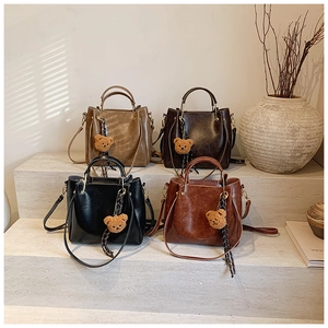 Detailed set of retro faux leather tote bags in four colors with bear charms and straps