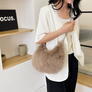 Detail of plush brown shoulder bag with silver beaded chain strap and metal hook