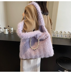 Close-up of light purple faux fur tote bag with pearl handle carried by a model