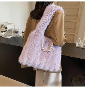 Detailed view of lavender faux fur tote bag with pearl handle worn over the shoulder