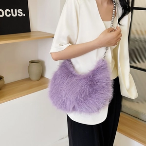 Detail of purple faux fur crossbody bag with silver beaded chain strap and fluffy texture
