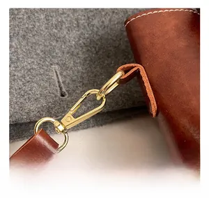 Detailed close-up of premium golden metal hook and leather strap with contrast stitching