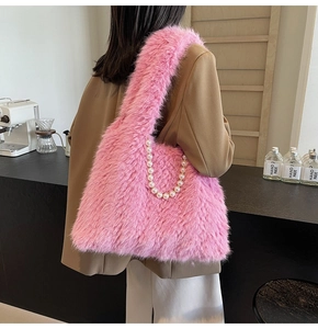 Detail of pink faux fur tote bag with pearl chain shown in a stylish cafe setting