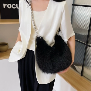 Detail of black faux fur shoulder bag with decorative silver metallic sphere chain