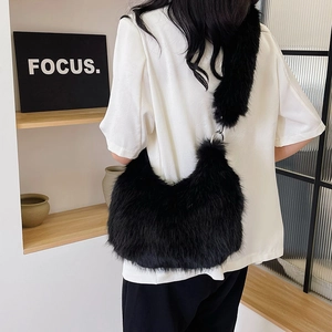 Detailed back view of a black faux fur shoulder bag with silver metal ring connectors