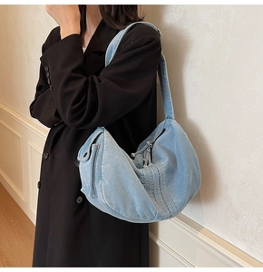 Light blue denim hobo bag on shoulder, casual stylish washed denim tote for women