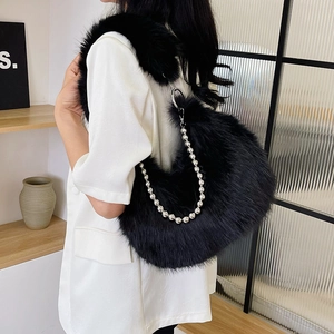 Detail of plush black crescent shoulder bag with silver beaded chain and fuzzy strap