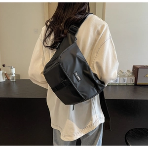 Close-up of waterproof nylon messenger bag with adjustable strap in urban setting