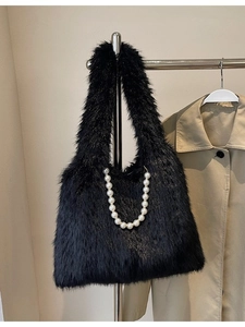 Black faux fur tote bag for women with pearl chain strap and plush winter texture