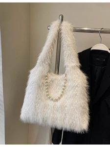 Faux fur tote bag with pearl handle and plush texture for women in winter fashion