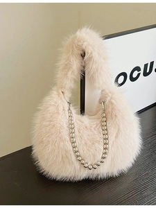 Faux fur handbag in light pink with plush texture and silver beaded metal chain