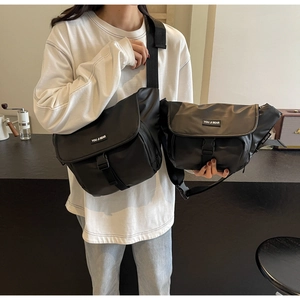 Black retro waterproof messenger bags in two sizes shown on model for comparison