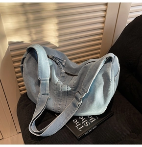 Detailed macro view of high-quality light blue denim fabric with smooth zipper closure