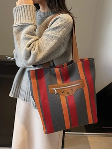 Large striped canvas tote bag with leather trim and metal rivets for women's daily commute
