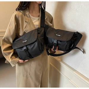 Detailed comparison of large and small black nylon messenger bags with buckle closures