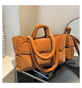 Close-up of caramel padded tote bag featuring soft quilted nylon and a thick shoulder strap