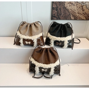 Close-up of plush faux fur trim and silver butterfly buckle on three autumn backpack colors