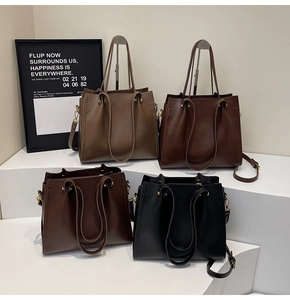 Detail view of large tote bags in four neutral colors with detachable shoulder straps