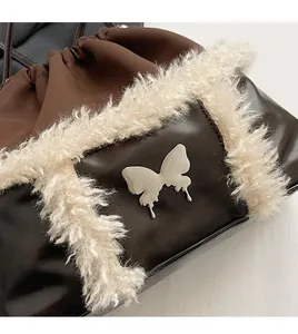 Detail of dark brown leather bucket bag with white faux fur trim and silver butterfly buckle