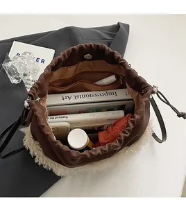Detail view showing large capacity and inner pockets of lamb wool bucket bag