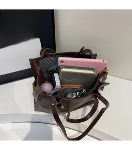 Deep brown tote bag showing spacious interior with iPad, umbrella, and daily essentials