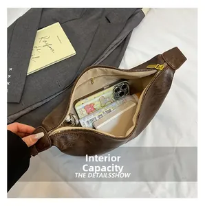 Detail view of large interior capacity and zipper pocket of brown vintage leather tote bag