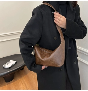 Detail shot of vintage brown leather tote bag with retro textures and zipper closure