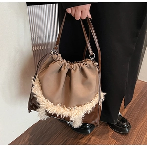 Detail of vintage tote bag featuring plush faux fur trim and leather drawstring closure