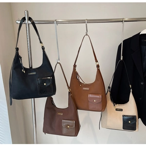 Detail of hobo shoulder bags in four colors with matte leather finish and metal logo