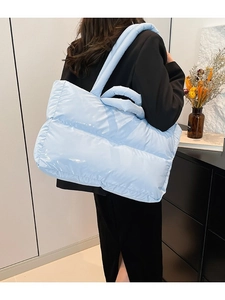 Light blue glossy padded puffer tote bag with quilted design and dual carry handles