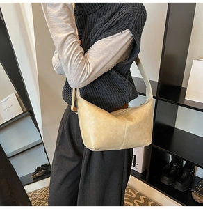 Detail of cream hobo bag showing fine stitching and smooth vegan leather texture
