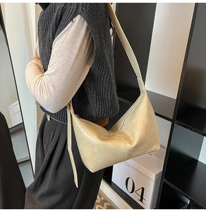 Side view of beige hobo shoulder bag with soft PU leather and elegant half-moon design