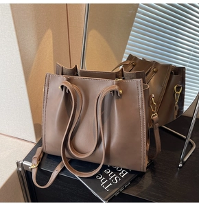 Detailed view of the caramel leather tote with reinforced metal hardware and stitching