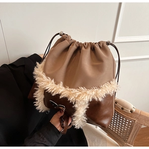 Detail of drawstring shoulder bag with brown leather and beige faux fur texture