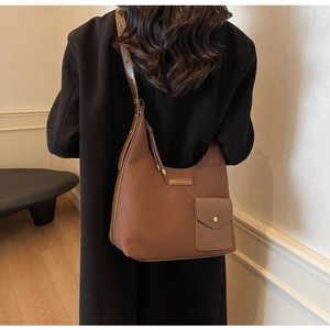 Detail of a brown matte Hobo bag with a gold metal buckle pocket and adjustable strap