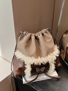 Women's chic beige bucket bag with plush white fur trim and silver butterfly buckle